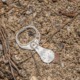 Old aluminum pull tab on sandy ground, a reminder that small actions can create peace of mind.